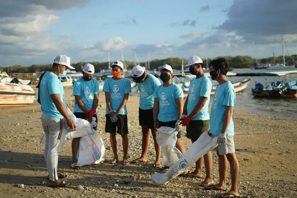 group of people standing on brown soil during daytime