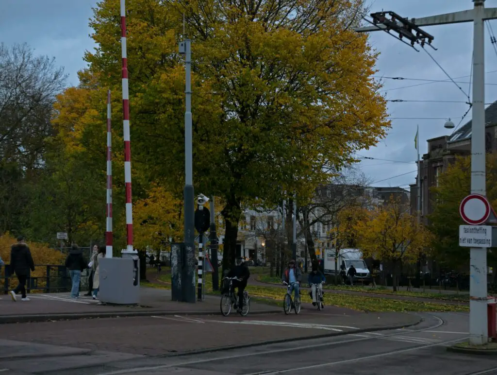 a group of people riding bikes down a street