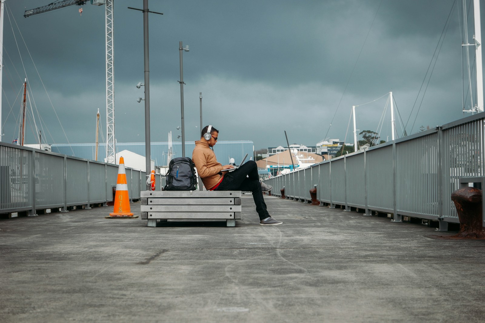 person sitting on bench wearing headphones