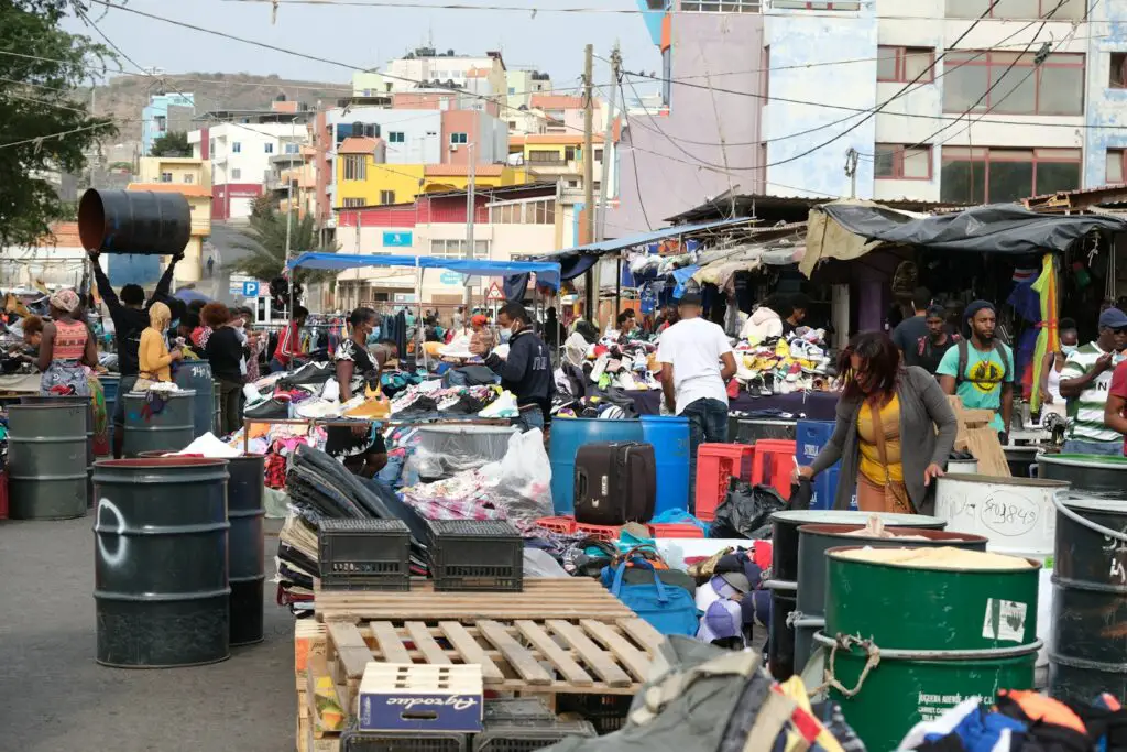 a group of people standing around a market