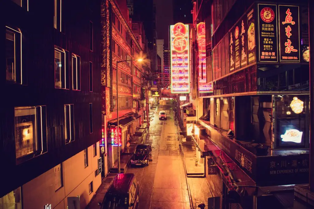 people walking on sidewalk during night time