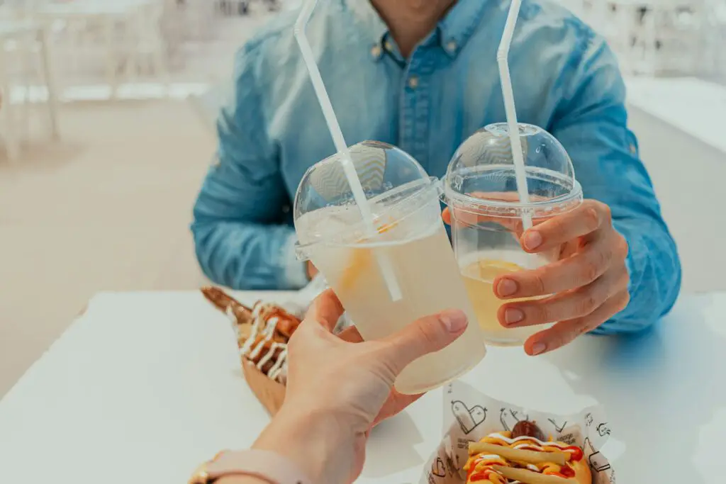 A couple of people sitting at a table with drinks