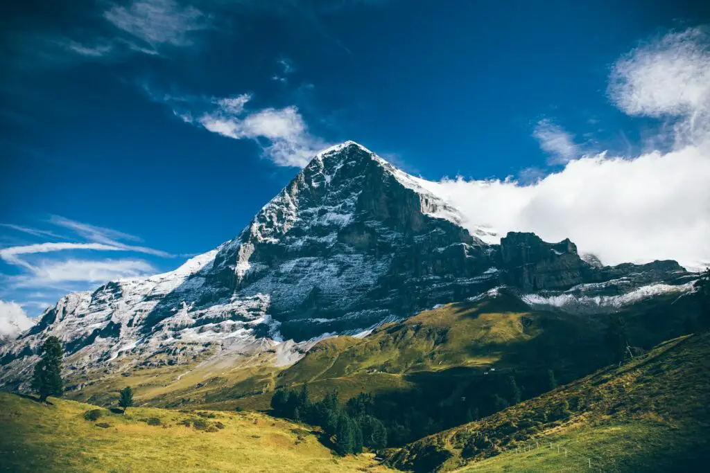 landscape photography of mountain under white clouds