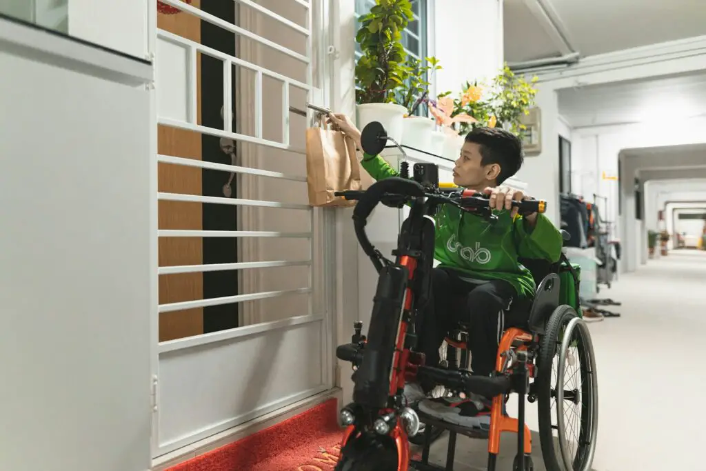 a man in a green shirt in a wheel chair