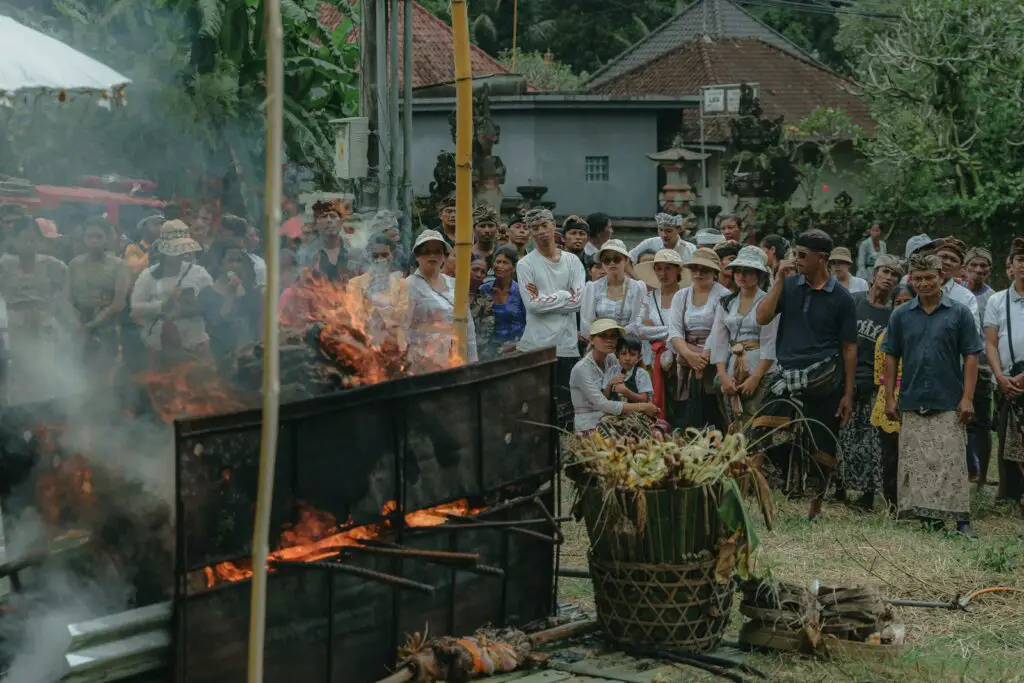 a group of people standing around a fire pit