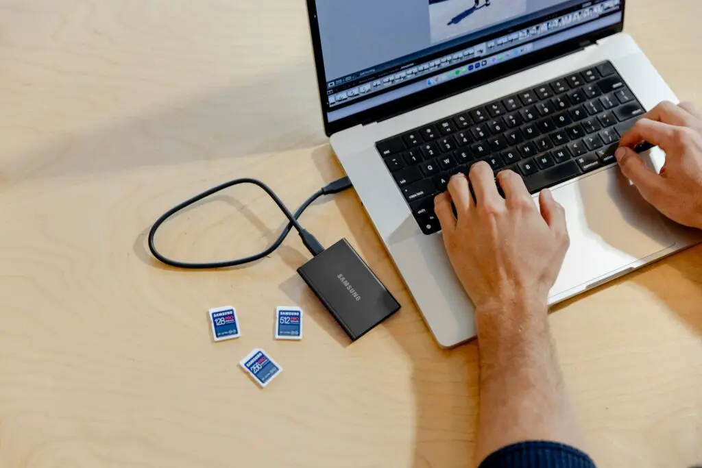 A person using a laptop computer on a table