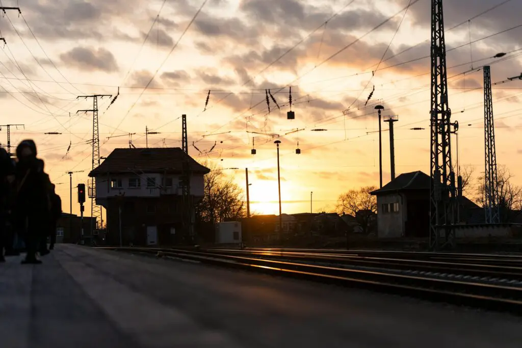 a group of people walking down a train track