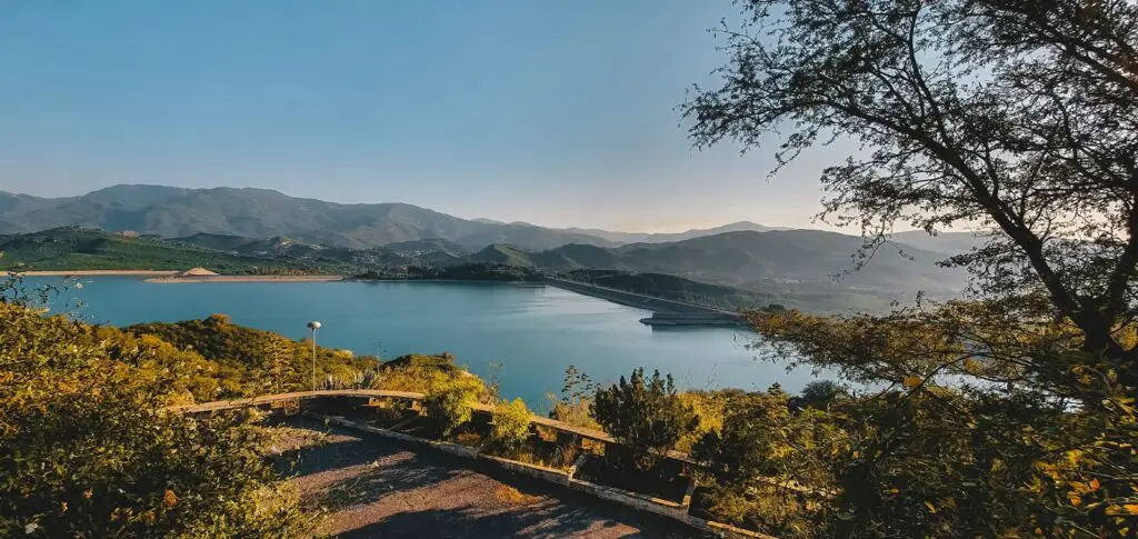 a scenic view of a lake surrounded by mountains