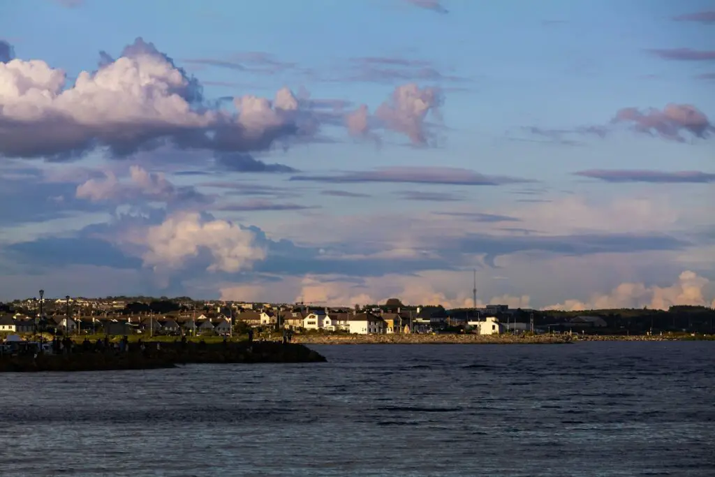 a large body of water with a city in the background