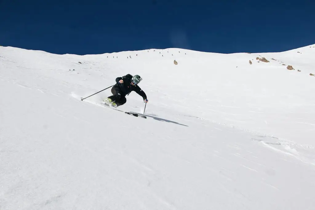 A person skiing down a snow covered slope