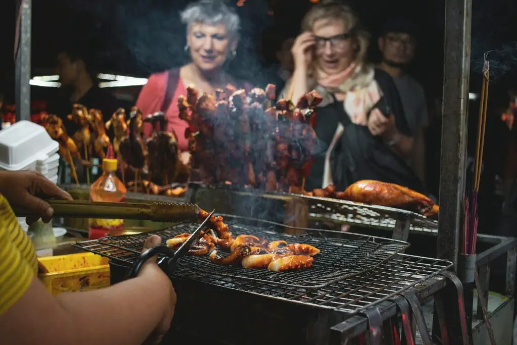 People Watching Barbecues Getting Cooked